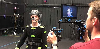 Person in studio wearing VR tracking suit being recorded